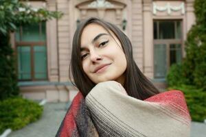 portrait of young attractive female in stylish outfit making selfie photo