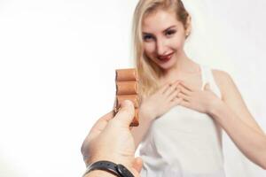 Lovely smiling teenage girl eating chocolate photo