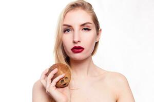 girl with a light natural make-up with coconut in her hand photo