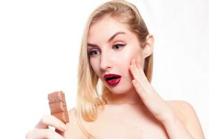 Lovely smiling teenage girl eating chocolate photo