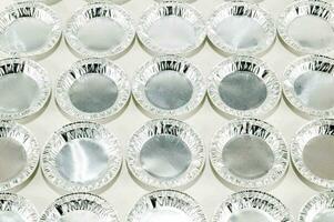 a large number of silver foil pie plates photo