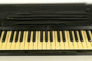 a black and yellow piano with keys on it photo