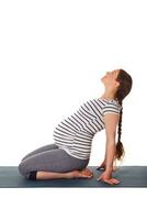 Pregnant woman doing yoga asana Ustrasana photo