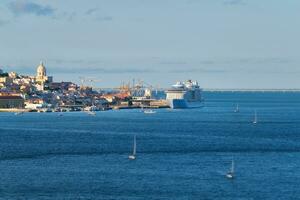 View of Lisbon view over Tagus river with yachts and boats on sunset. Lisbon, Portugal photo