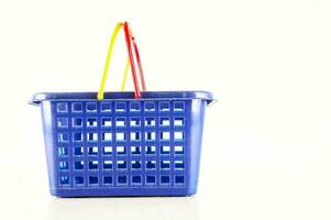 a blue plastic shopping basket with a yellow handle photo