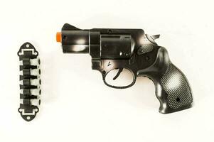 a black revolver with orange tips on the side photo