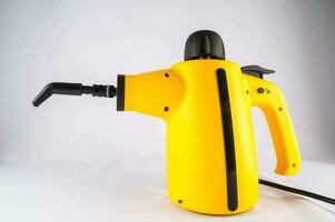 a yellow electric drill with a black handle photo