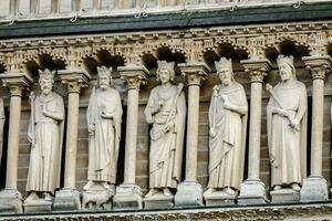 statues of saints on the facade of a building photo