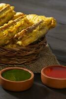 Indian Fried Snack Bread Pakora or Bread Bhaji Served with Tomato Ketchup, Green Chutney it is Made From Bread Slices photo