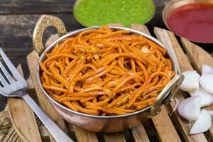 Spicy Fried Vegetable Veg Chow Mein on Wooden Table photo