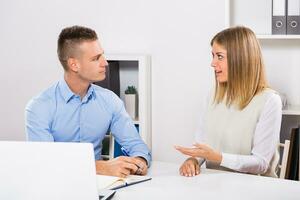 Businessman is interviewing young woman candidate for job. photo