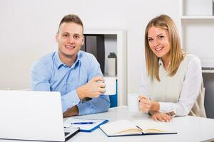 Businesswoman and businessman are having coffee break. photo