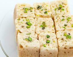 Indian Traditional Famous Sweet Food Mysore Pak or Mysoor Pak on White Background photo