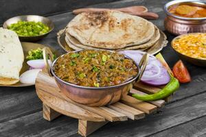 Indian Cuisine Sev Tamatar on Wooden Table photo