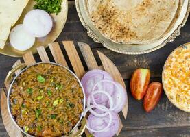 Indian Cuisine Sev Tamatar on Wooden Table photo