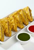 Indian Fried Snack Bread Pakora or Bread Bhaji Served with Tomato Ketchup, Green Chutney it is Made From Bread Slices photo