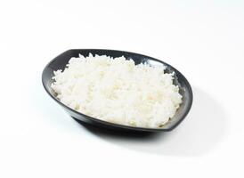 bowl of boiled rice on white background photo