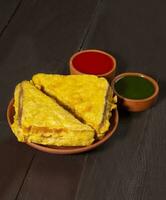 Indian Fried Snack Bread Pakora or Bread Bhaji Served with Tomato Ketchup, Green Chutney it is Made From Bread Slices photo