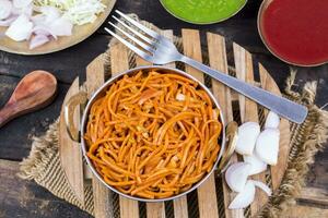 Spicy Fried Vegetable Veg Chow Mein on Wooden Table photo