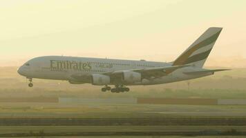 BANGKOK, THAILAND MARCH 01, 2023 Double deck Airbus A380 of Emirates landing at Suvarnabhumi Airport. Aircraft arriving. Huge four engine plane. Airliner in the sunset sky video