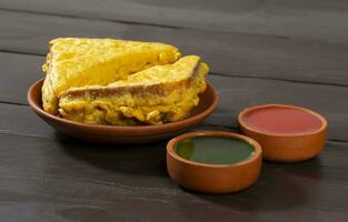 Indian Fried Snack Bread Pakora or Bread Bhaji Served with Tomato Ketchup, Green Chutney it is Made From Bread Slices photo