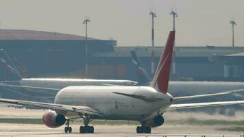 MOSCOW, RUSSIAN FEDERATION JULY 30, 2021 Airplane of Royal Flight taking off, rear view. Jet plane backlit on the runway. Row of airplanes parked video