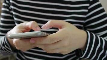 Close up hands of teen millennial woman using smartphone video