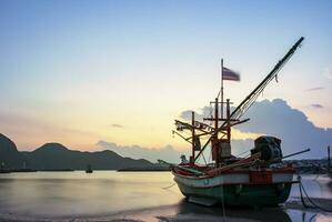 beautiful sun rising sky and local fishery boat at klong warn beach prachuap khiri khan southern of thailand photo