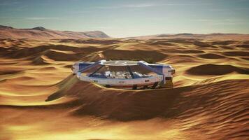 futuristic glass building in desert dunes video
