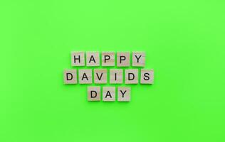 On March 1, happy St. Davids day, a minimalistic banner with an inscription in wooden letters photo