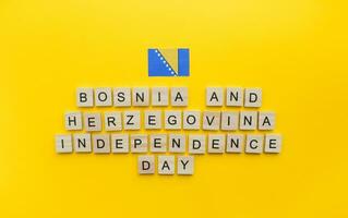 On March 1, Independence Day of Bosnia and Herzegovina, a minimalistic banner with an inscription in wooden letters on an orange background photo