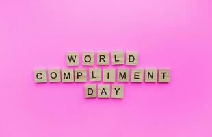 March 1, World compliment day, a minimalistic banner with an inscription in wooden letters photo