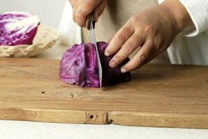 Close Up Female Hand Sliced Purple Cabbage photo