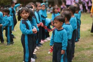 Magelang,Indonesia.12-05-2023.group of kindergarten school children and teachers playing and learning outdoors. photo