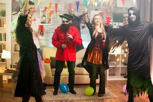 Young man dressed up like a pirate at a halloween party with his friends. photo