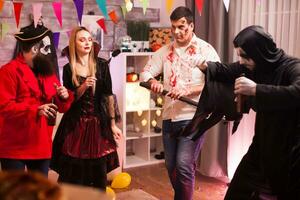 Group of friends in halloween costume dancing. photo