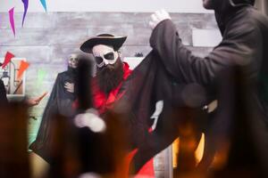 Man wearing creepy medieval pirate outfit while celebrating halloween with his friends. photo