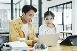 Young students campus helps friend catching up and learning. photo