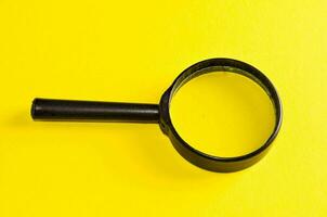 magnifying glass on yellow background photo