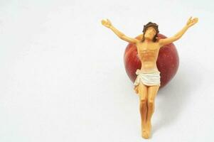 a figurine of jesus on an apple photo