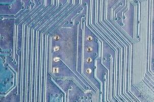 a close up of a circuit board with a blue background photo