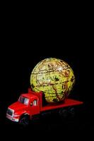 a toy truck with a globe on top of it photo