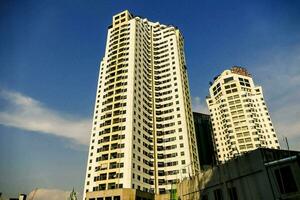 a tall building with a blue sky in the background photo