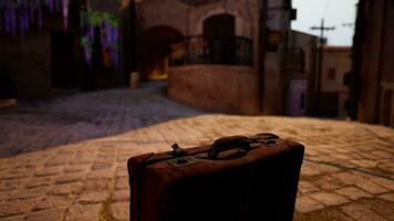 A piece of luggage sitting on a cobblestone street video