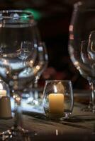 Candle on a dinner table photo