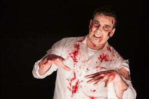 Man in shock after being possessed with blood all over his body. Creative makeup for halloween. photo