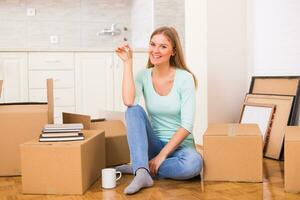 Beautiful woman holding key of her new home. photo