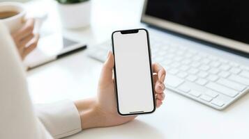 Close up view businessman holding smart phone with blank screen while standing in modern office. photo