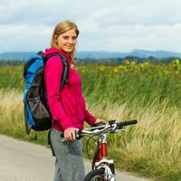 Woman hiker  with a bike photo
