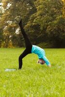 Woman doing yoga in nature photo